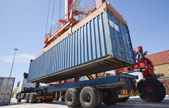 Container being loaded on truck